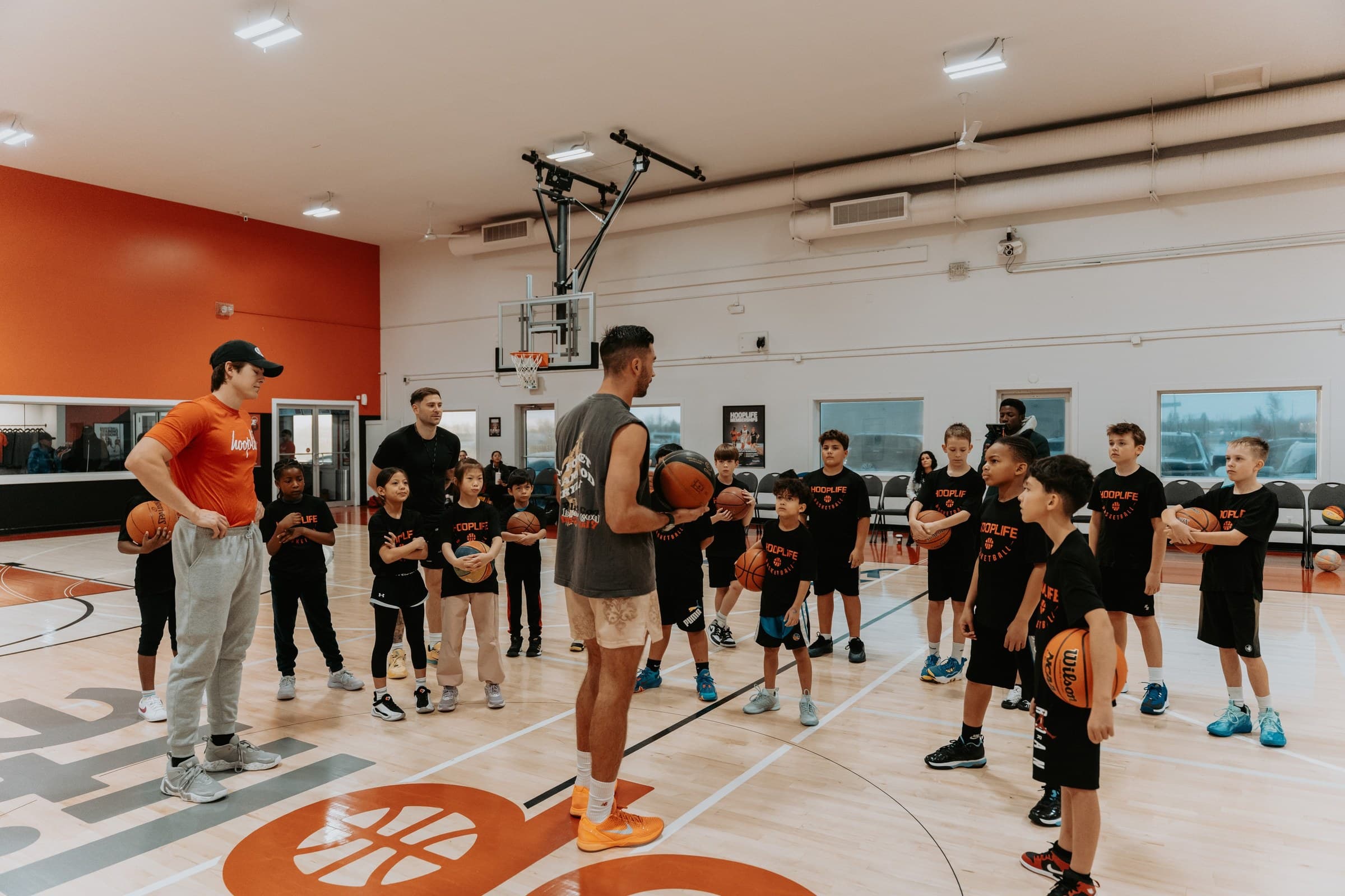 Jordan Lawley and Marek Klassen with a full clinic of kids at centre court at the HoopLife Centre in Regina