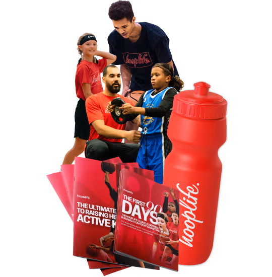 A HoopLife coach with three young players at the HoopLife Centre