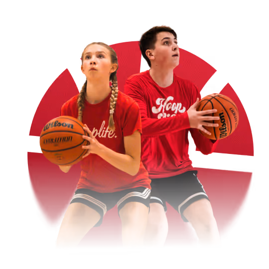 Two young basketball players in red shirts and black shorts holding basketballs, preparing to shoot.