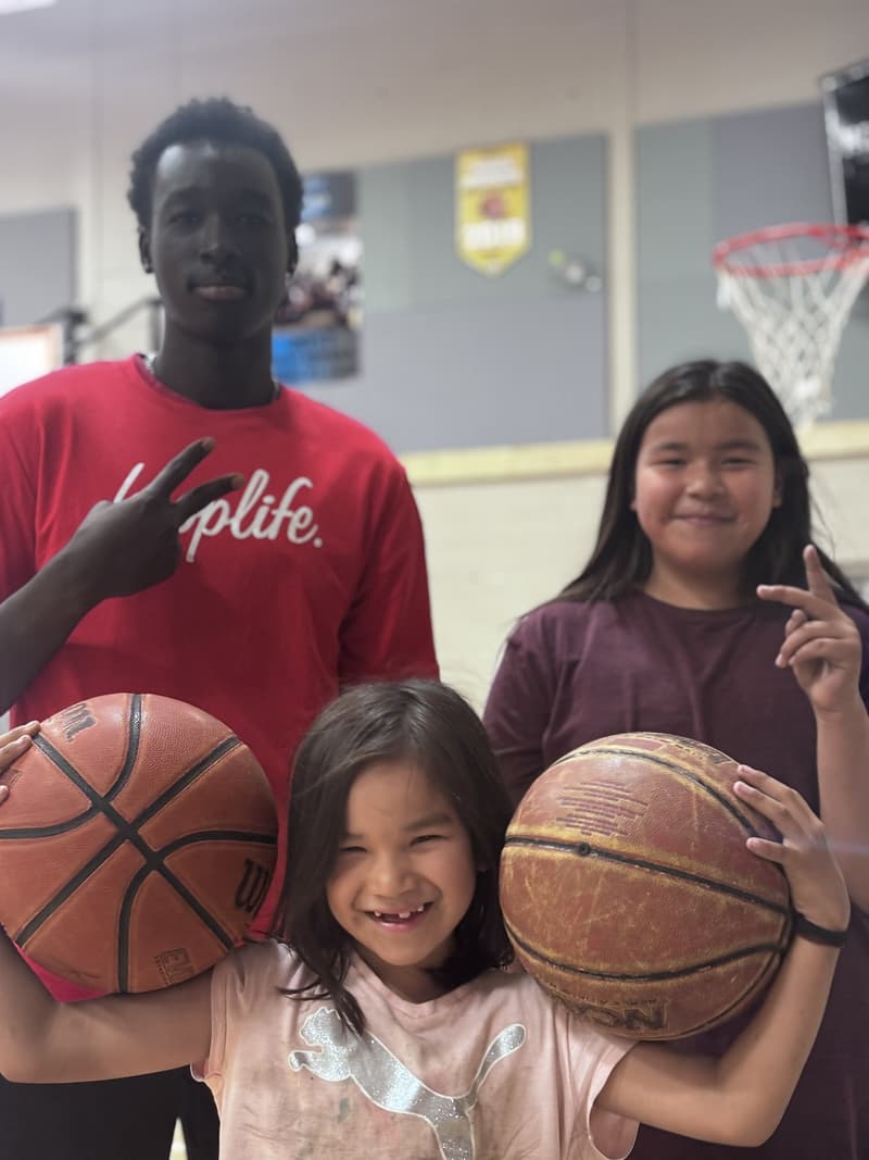 A HoopLife coach with a group of girls at a community clinic