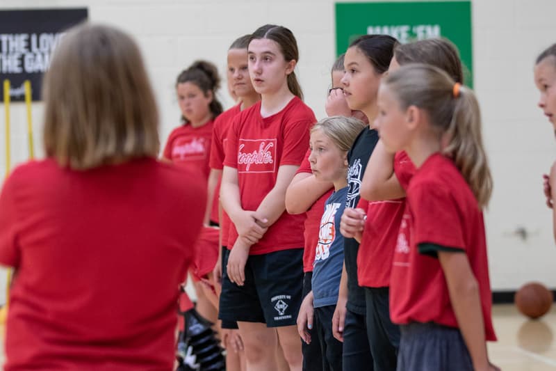A HoopLife coach with a line of girls at a Girls Only session