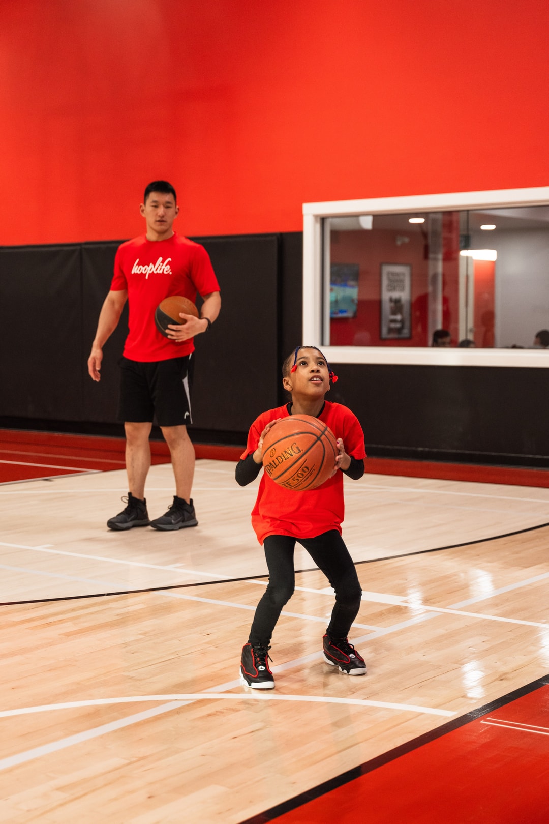 A HoopLife coach watching a single player work on his shot