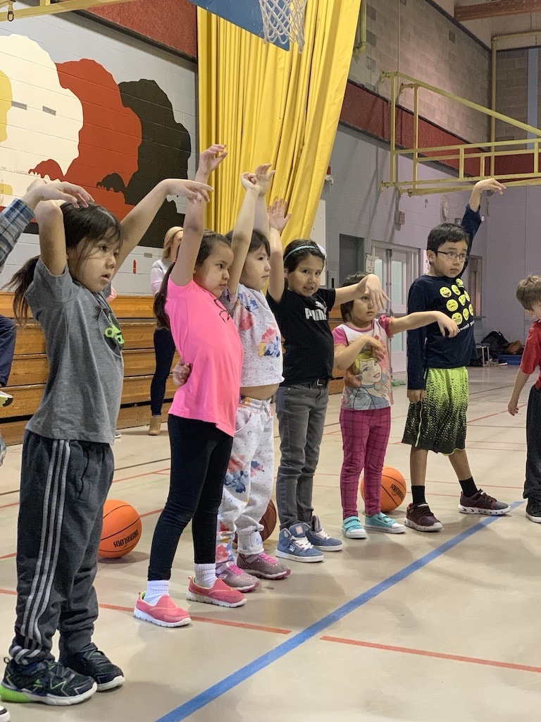 A young player holding her follow-through at the Standing Buffalo clinic