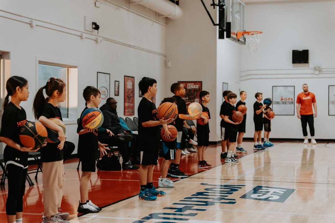 A line of HoopLife campers working through a ball-handling drill with their coach in Regina