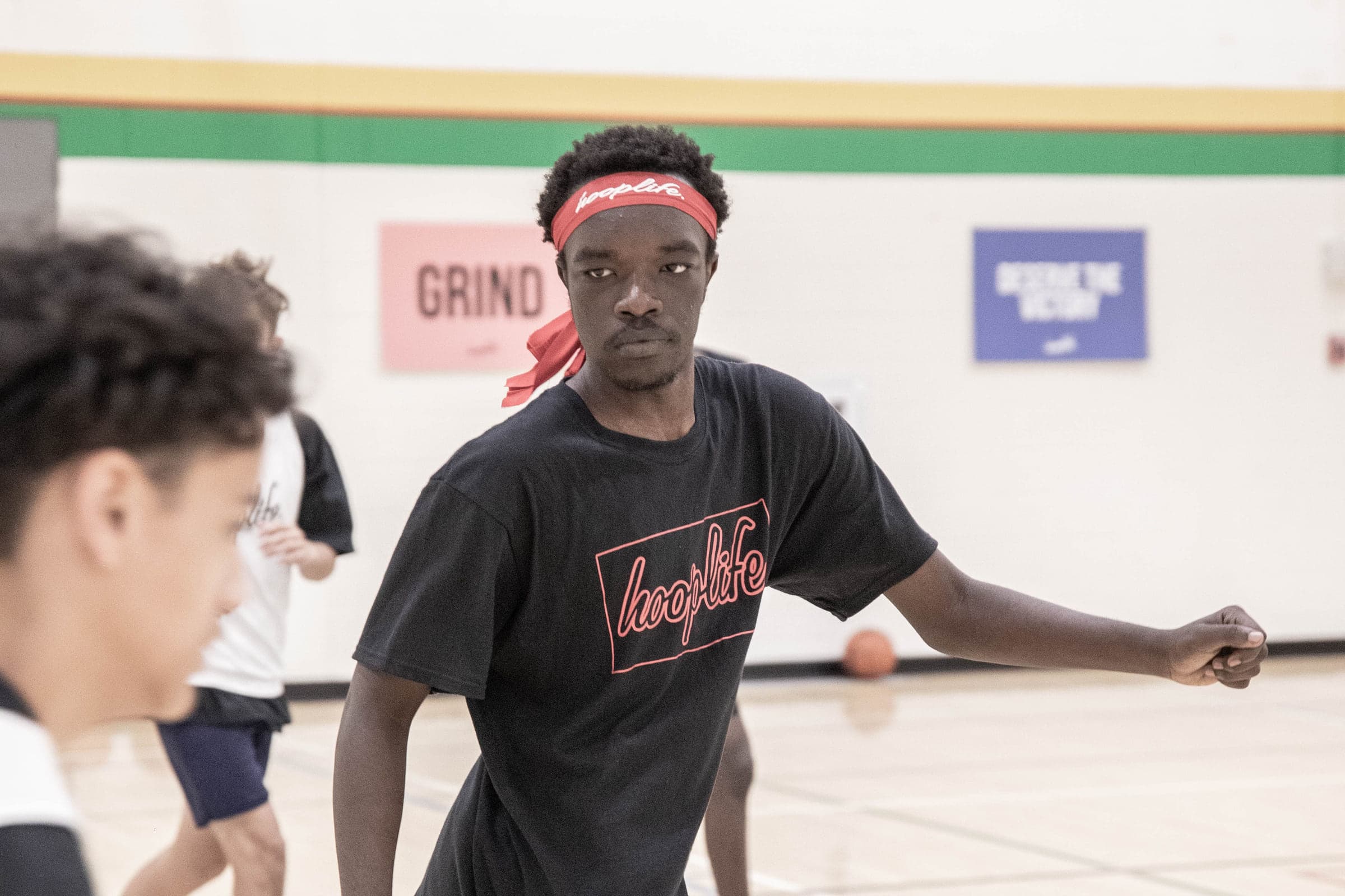 An older player driving past a defender at the HoopLife Centre in Regina