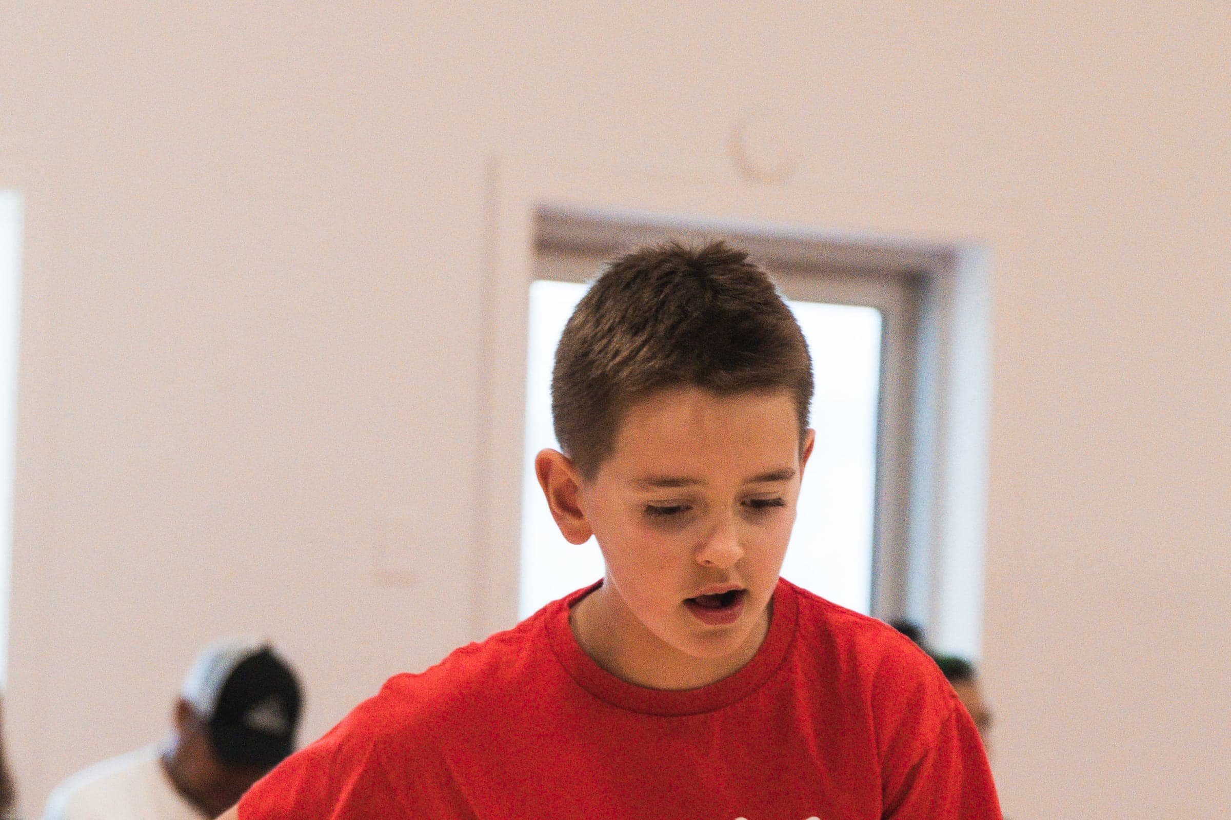 A young HoopLife player listening closely during a session in Regina