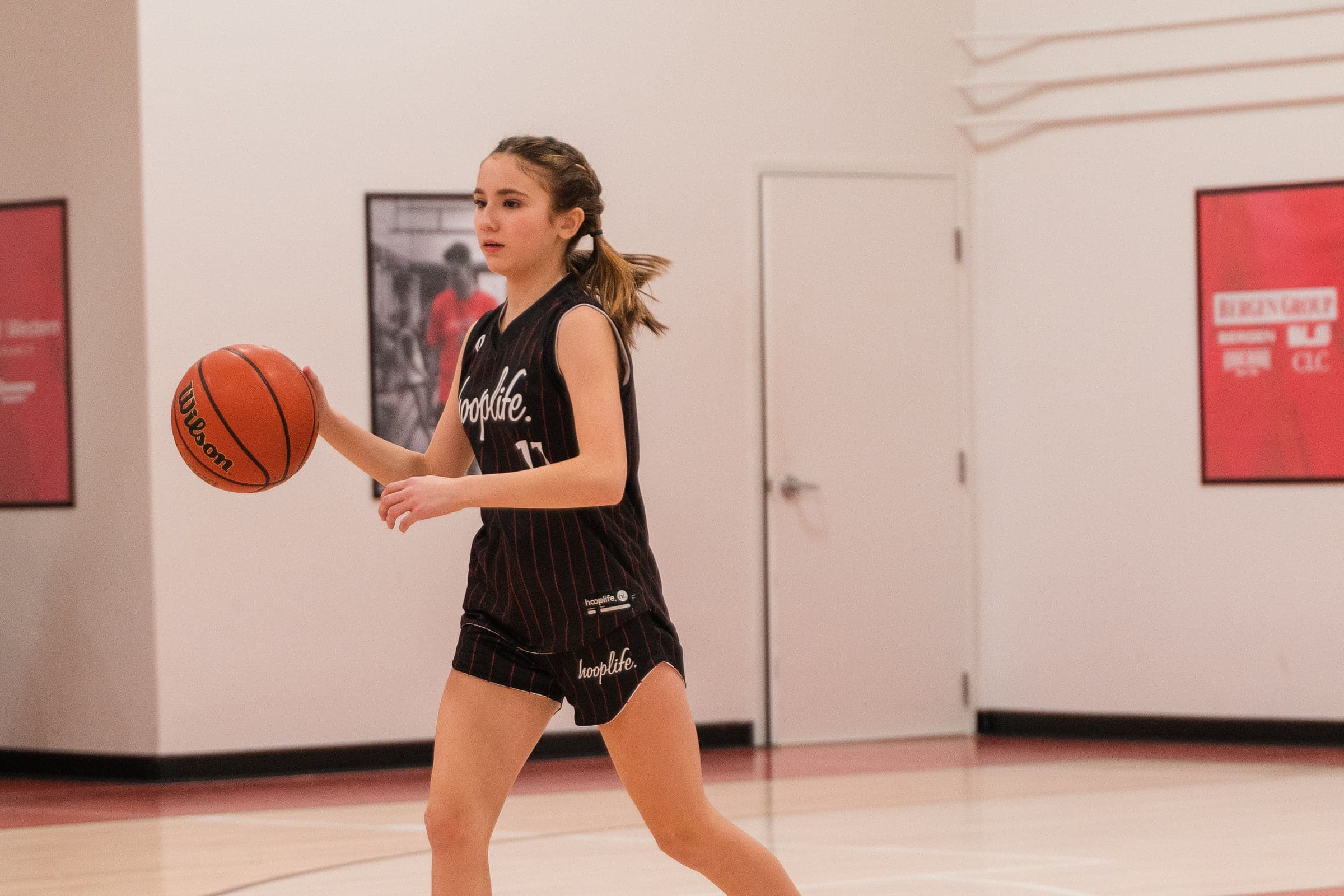 A young guard bringing the ball up the floor at HoopLife in Regina