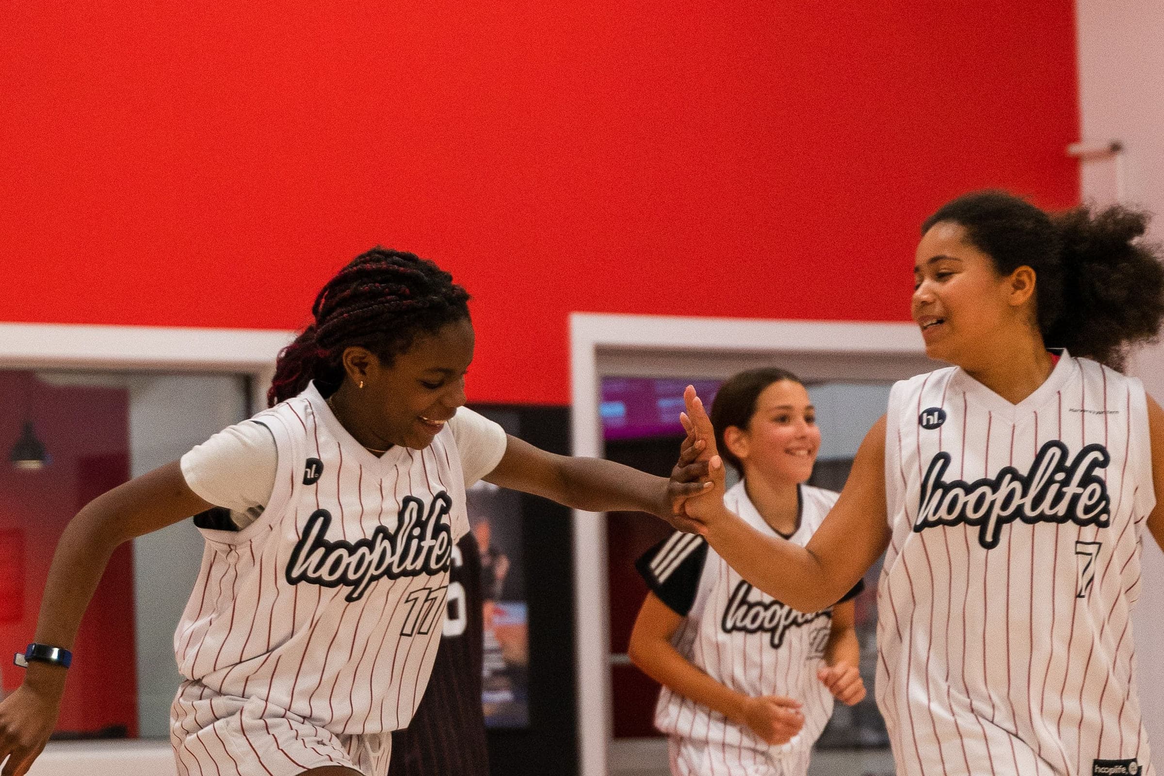 HoopLife League players high-fiving each other during a game in Regina