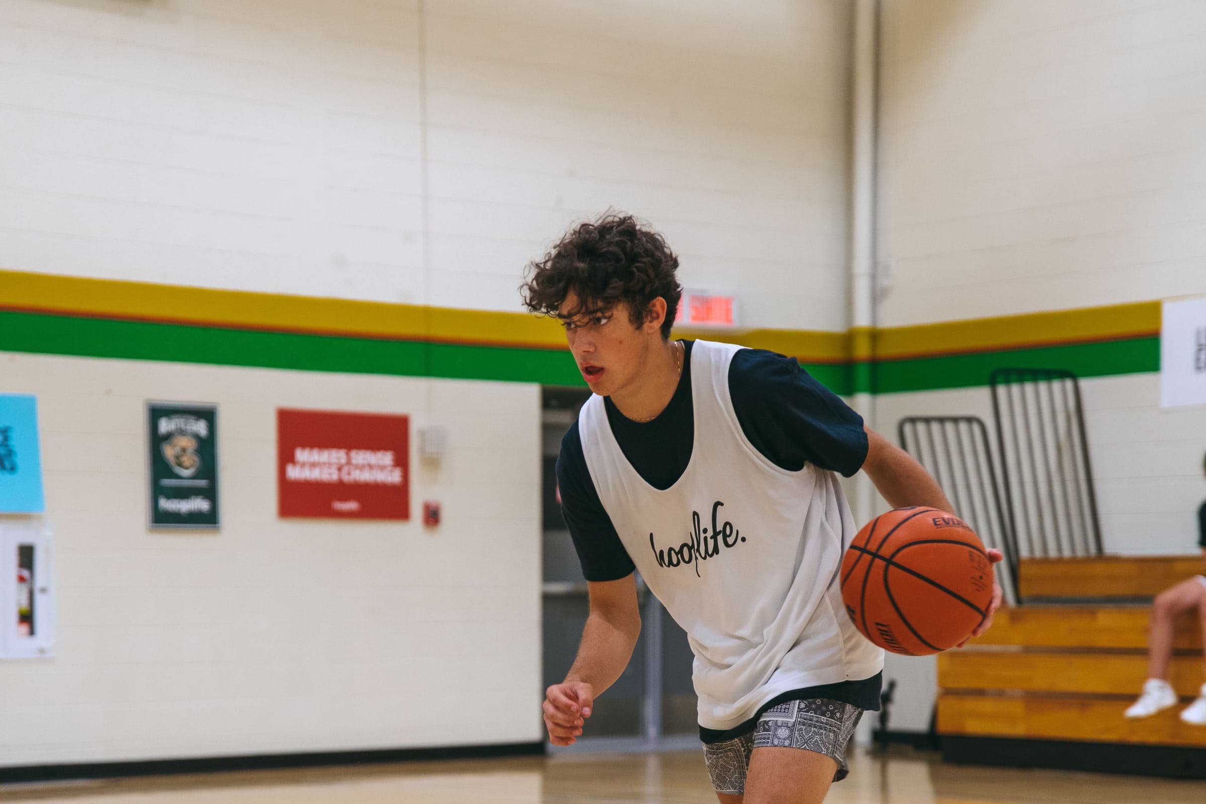 An older player driving with the ball during a game at HoopLife