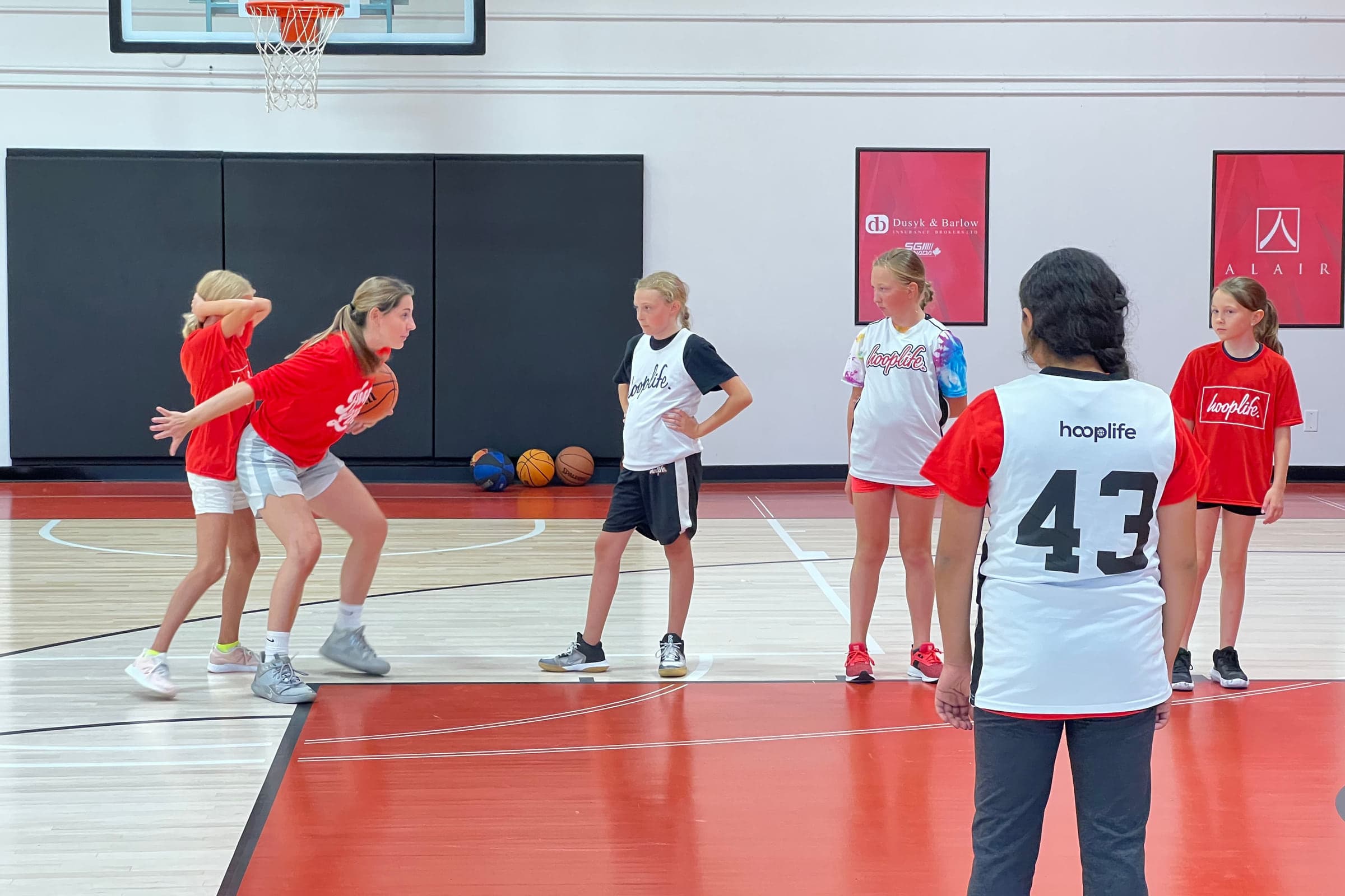 Young players spread across the court during a summer session at HoopLife in Regina