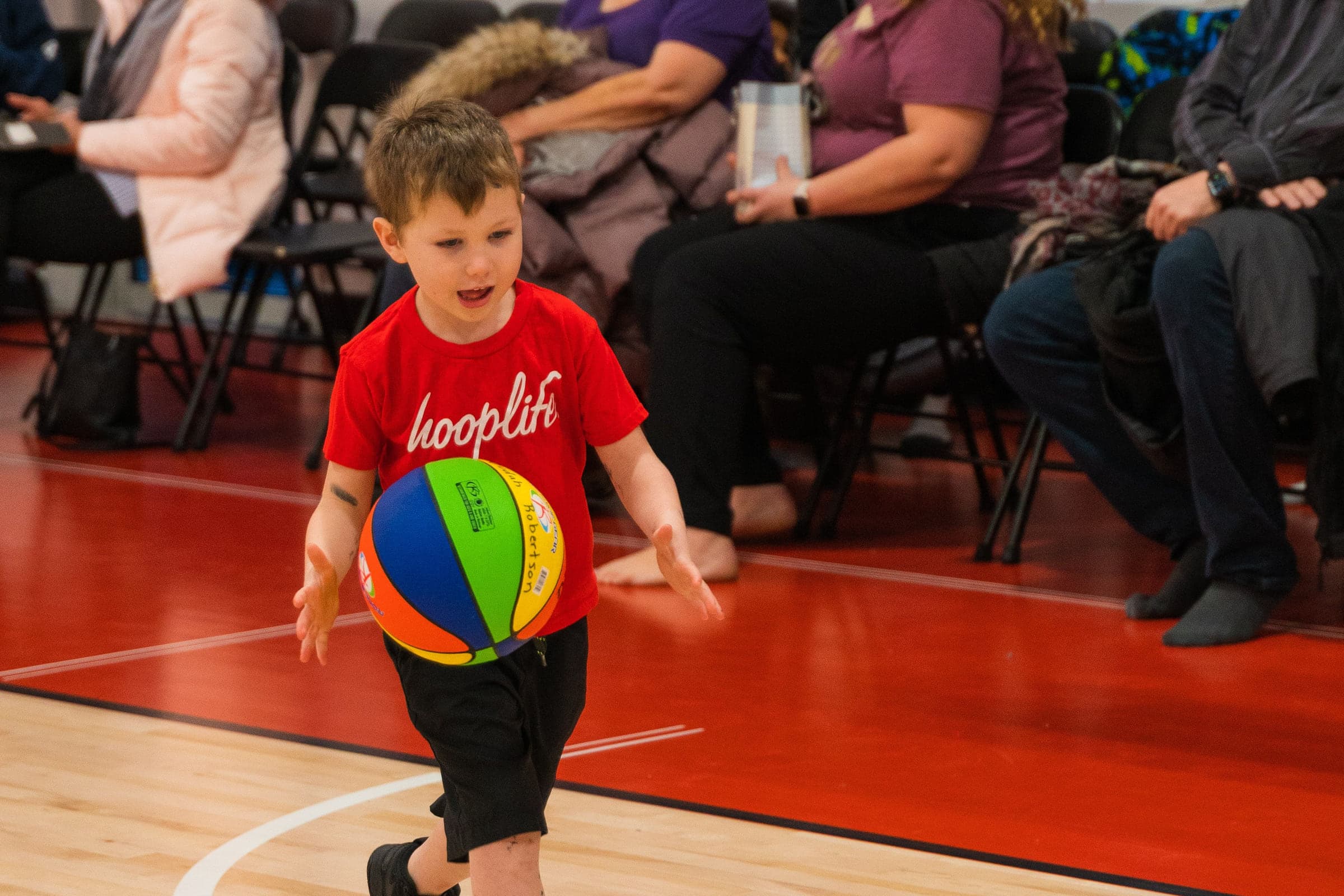 A Young Stars player dribbling in front of watching parents at HoopLife in Regina