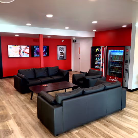 The HoopLife lounge with couches, televisions and vending machines