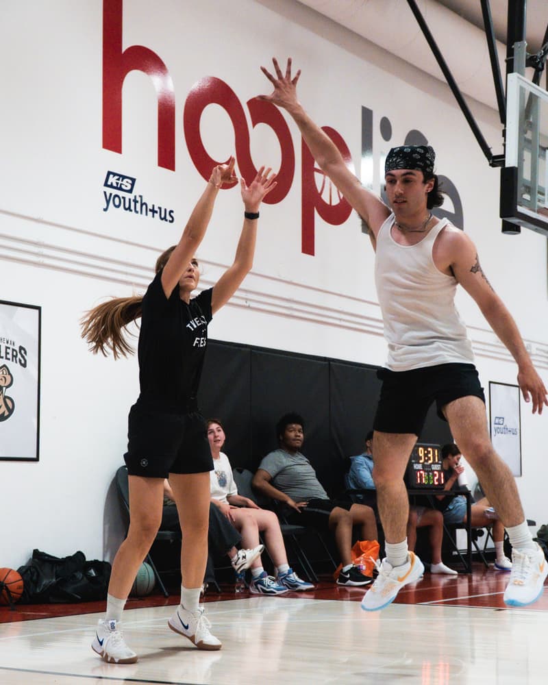 A jumper going up over a leaping defender in the co-ed adult league