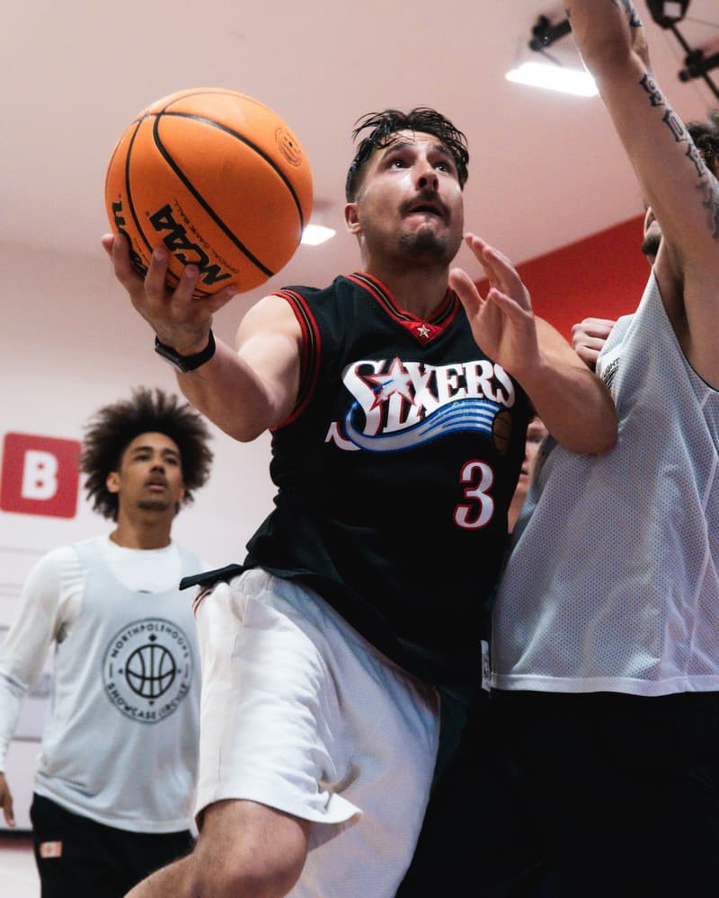 An adult league player finishing through contact at the rim