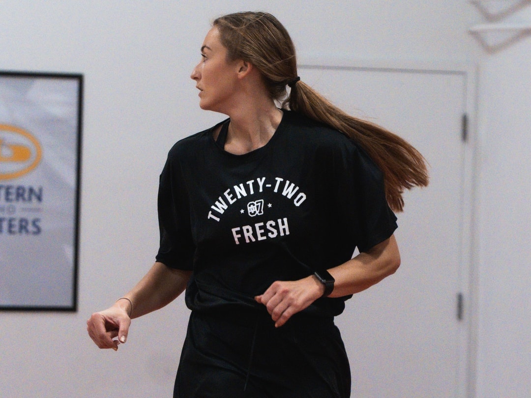A woman bringing the ball up in the co-ed adult league