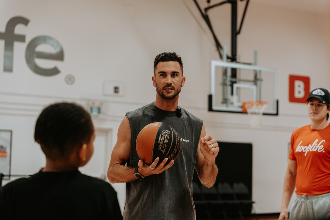 A HoopLife coach teaching a player during a session
