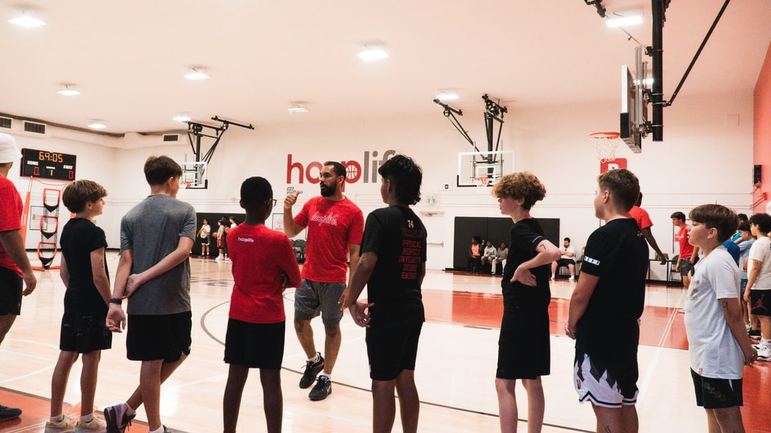A group of HoopLife members together on the court at the HoopLife Centre
