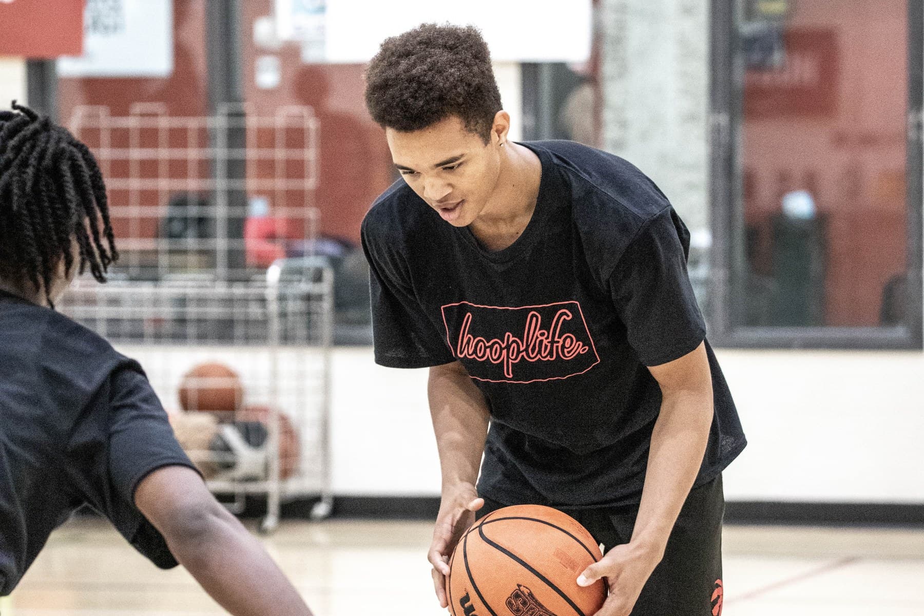 A HoopLife coach welcoming a young player on the Regina court