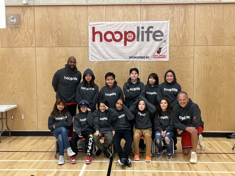 The Iskut clinic group in matching HoopLife hoodies under the HoopLife banner