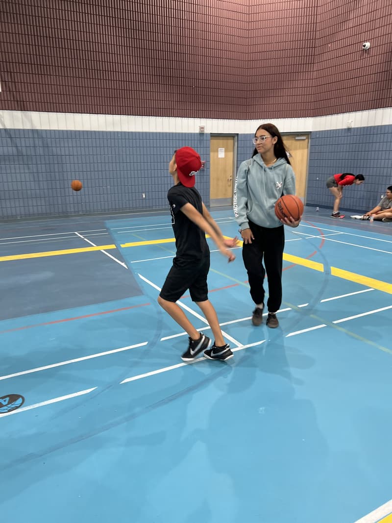 A boy and a girl playing together on the court at the Kawacatoose clinic