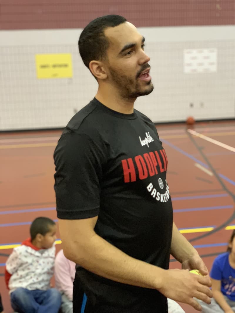A HoopLife coach mid-lesson at a community clinic
