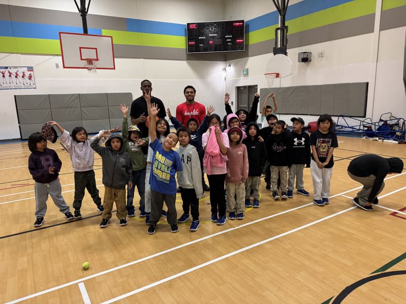 Kids cheering with their HoopLife coaches at the Pikangikum clinic