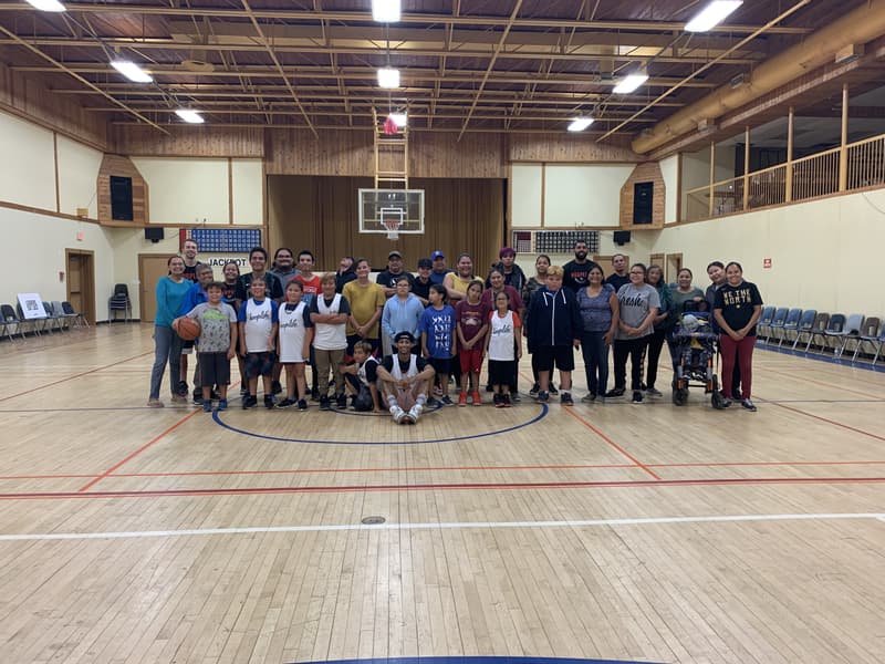Kids, parents and elders of Star Blanket together on the community hall court