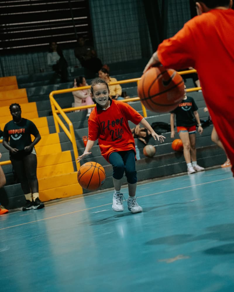 A young player dribbling with a huge smile at the Costa Rica clinic