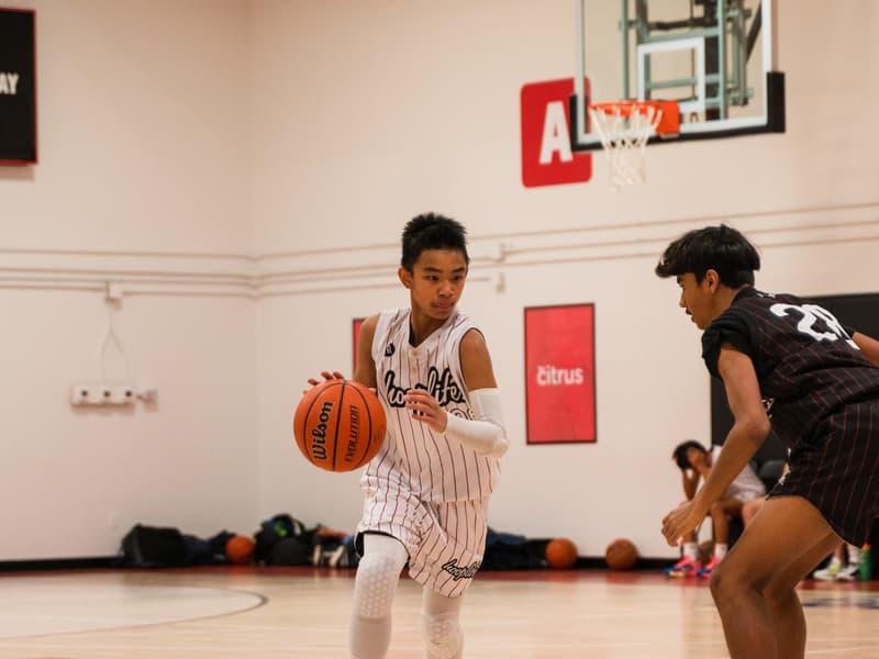 A HoopLife League player taking on a defender