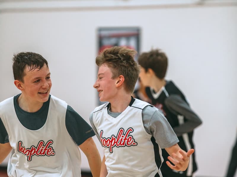 HoopLife League teammates sharing a laugh mid-game