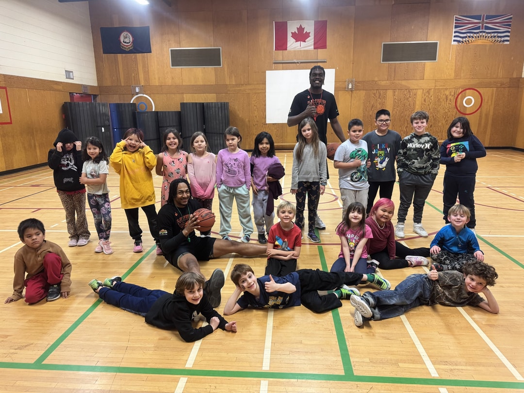 Coaches and kids hamming it up on the gym floor at the Lillooet clinic