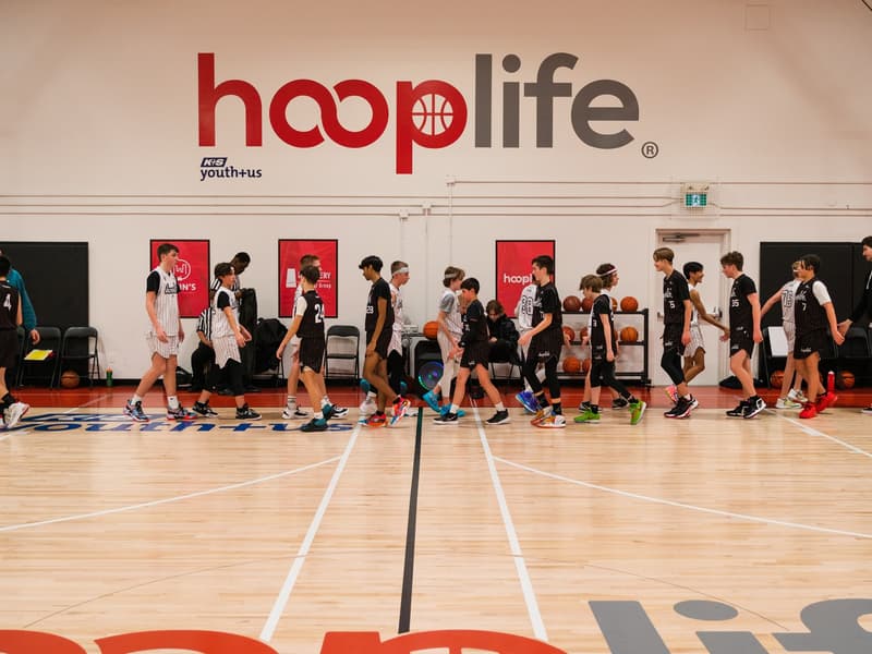 A full gym of players training under the hooplife wall