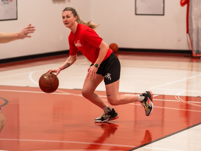 A player bringing the ball up the red court