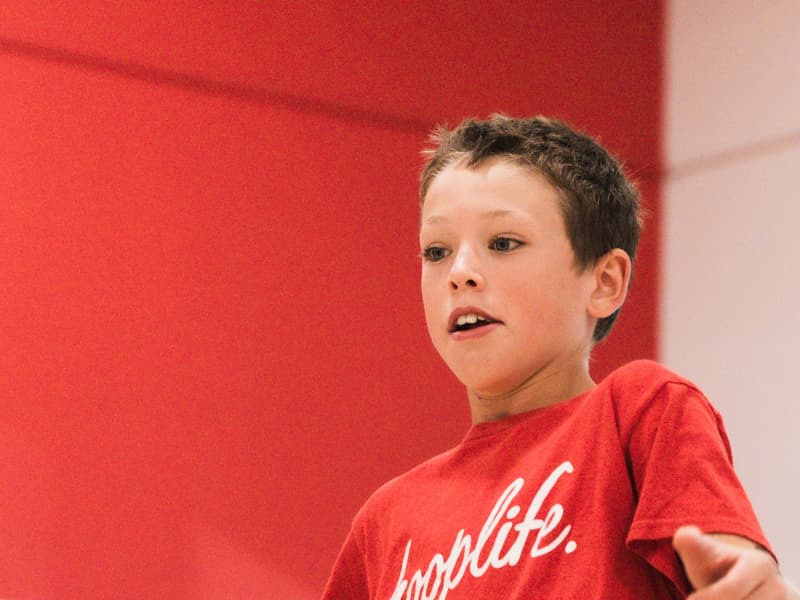A young player mid-possession in a 3x3 game