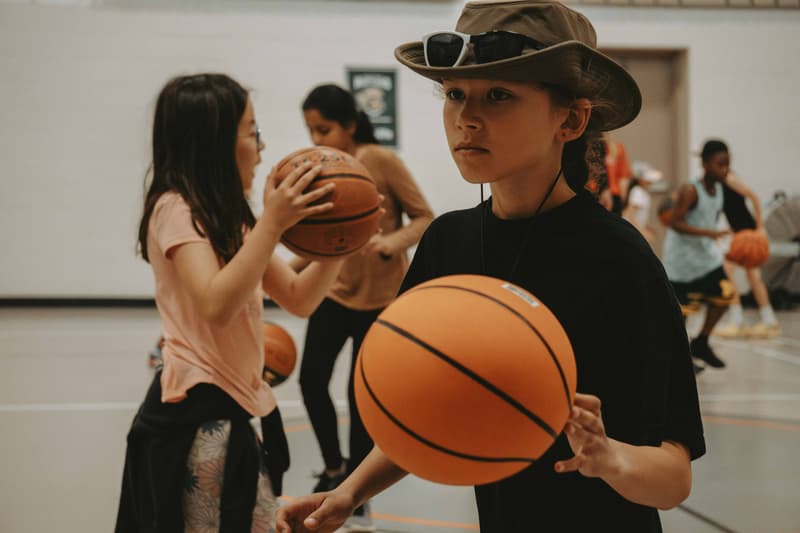 A young player lining up a pass at a HoopLife community clinic