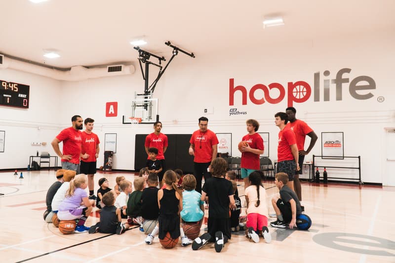 The HoopLife coaching staff with a seated Young Stars class