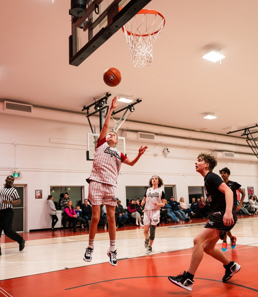 A girls division player rising for a layup in Regina