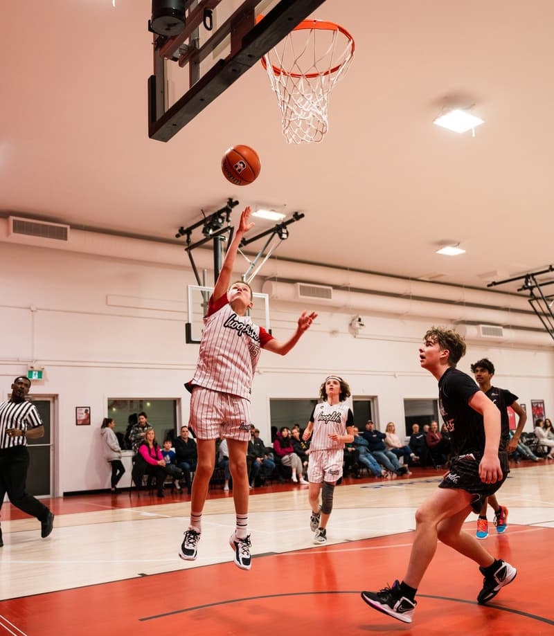 A girls division player rising for a layup in Regina