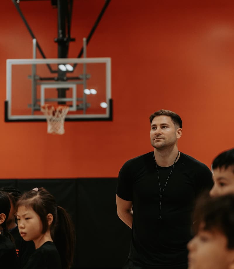 A HoopLife coach talking a group through a drill